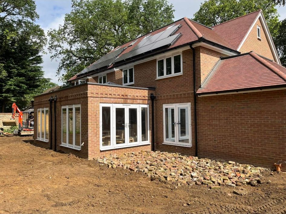 New build red brick house with multi-pitched tile roof, dormers and solar panels β Green's Brickwork, Hampshire