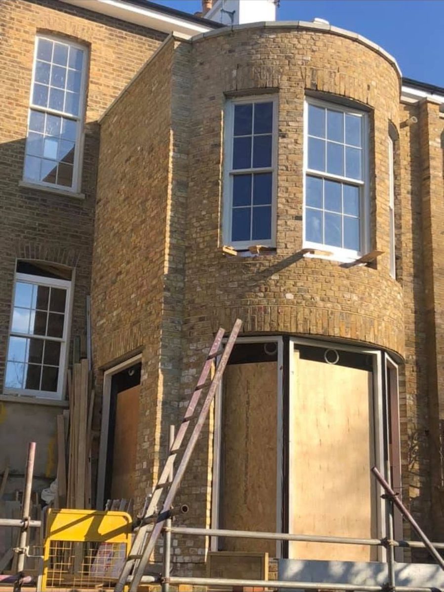 Yellow London stock brick townhouse with curved bay window and sash windows β heritage brickwork by Green's Brickwork